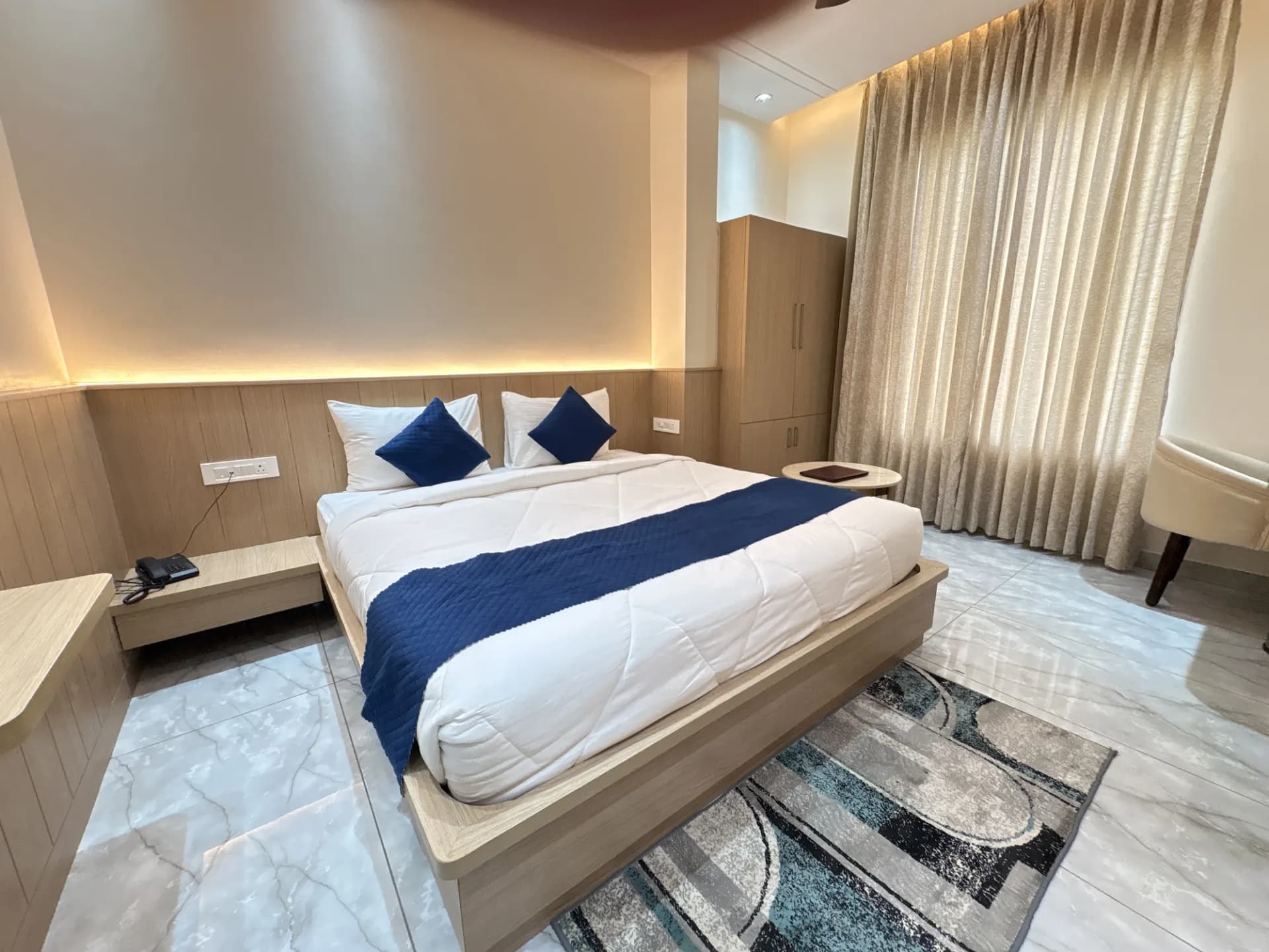 Double room with king bed and warm lighting at Jay Mahal Hotel